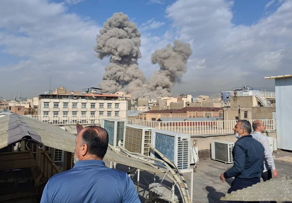 People watch as smoke rises on the skyline after an explosion in Tehran, Iran, Saturday, Feb. 28, 2026.(AP Photo)