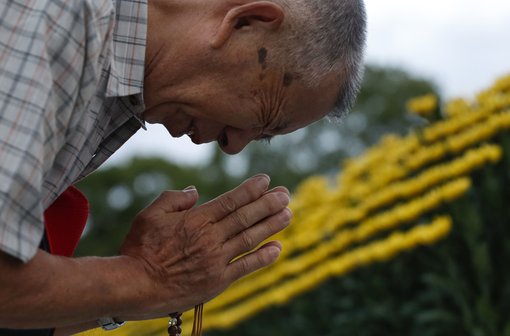 A man prays in front of the cenotaph for A-bomb victims at the Peace Memorial Park in Hiroshima, on Aug. 6, 2019, as the western Japan city marked the 74th anniversary of the U.S. atomic bombing. 